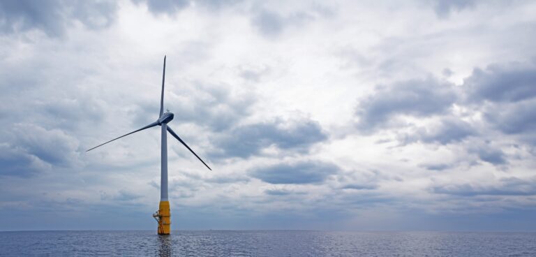 A wind turbine against a cloudy sky