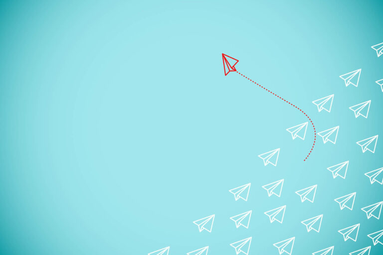 An abstract image of a paper airplane flying through a blue field